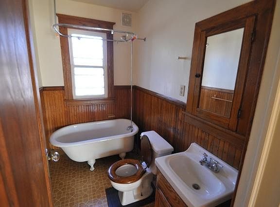 Original bathroom with deep porcelain tub.