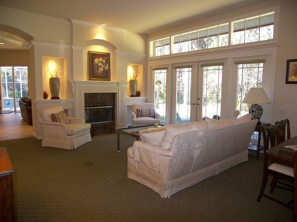 Formal living room with fireplace and french doors to private brick patio