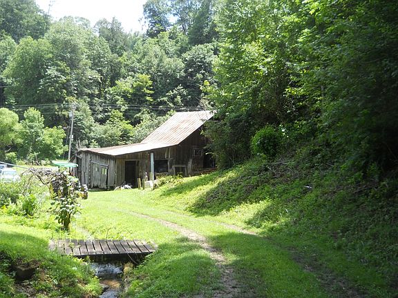 Barn from the rear; foot bridge over the spring