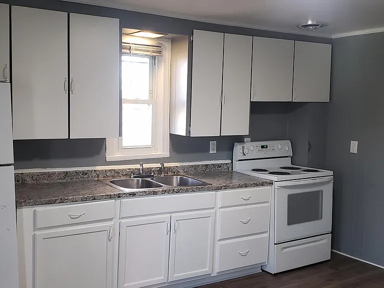 Kitchen viewed from front door entry to unit.