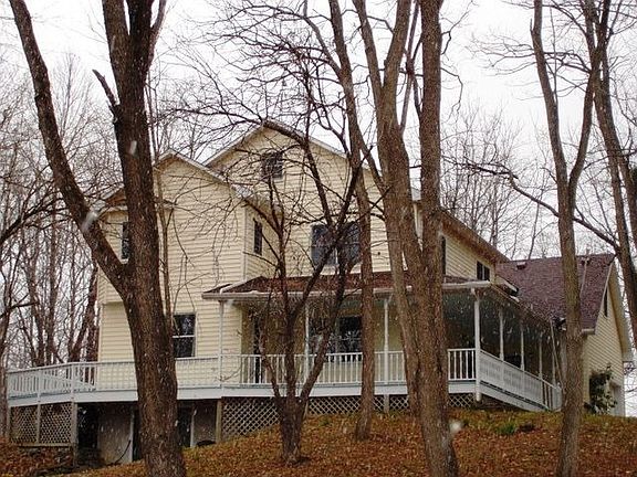 This home has a wraparound porch and is on 2.67 lovely acres.
