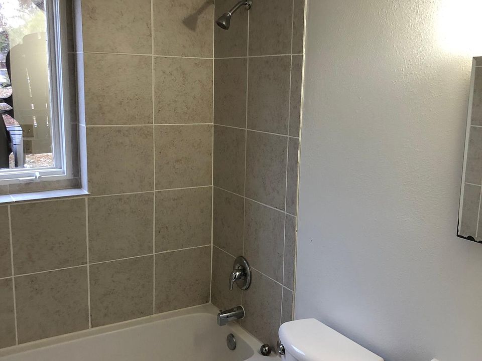 Bathroom with new tub, tile surround for tub and flooring