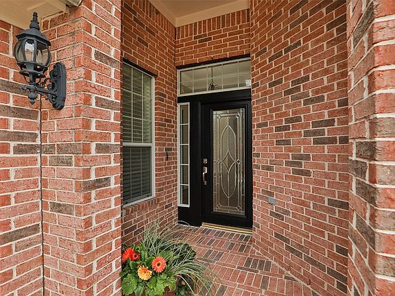 Full brick exterior and freshly painted front door with sidelight and transom windows. New door hardware is an updated brushed nickel.