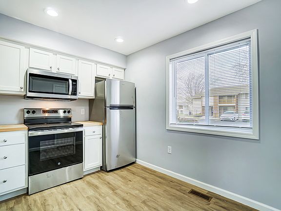Kitchen with butcher block counter and stainless appliances