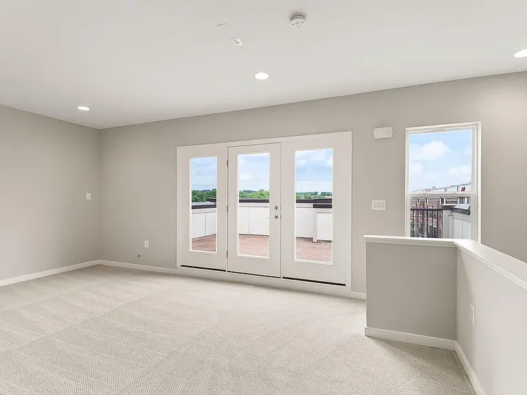 4th floor BONUS room with doors leading to rooftop deck.
