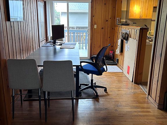 Dining area and sliding doors to porch. Kitchen on right