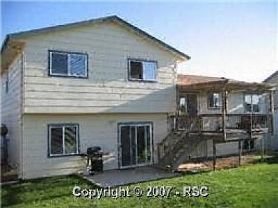 Back yard with custom deck and two storage sheds