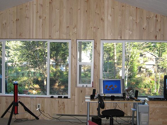 New pine paneling in living room overlooking river.
