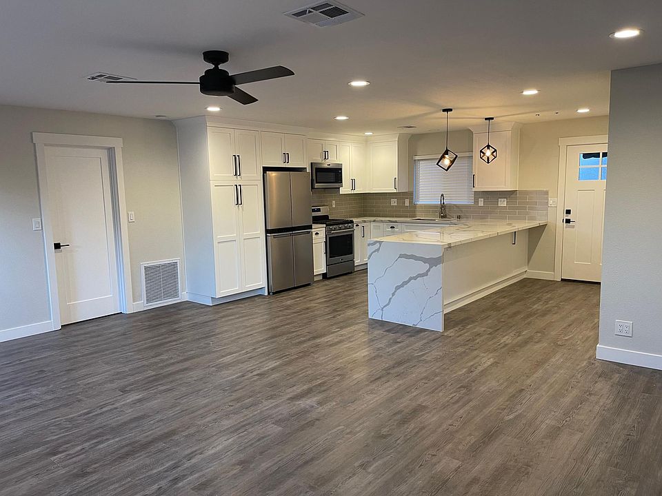 Open concept great room for living and entertaining. Exceptionally large kitchen with custom pull-out storage drawers, pantry and new stainless appliances.