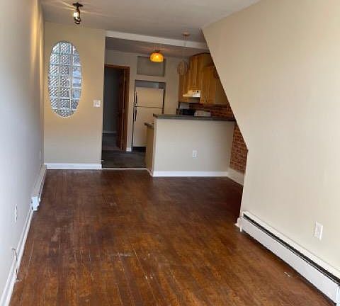 View from living room/ foyer into dining area/ kitchen