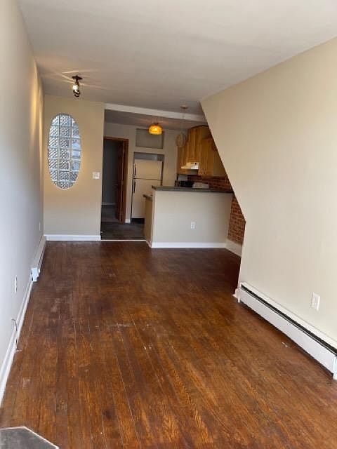 View from living room/ foyer into dining area/ kitchen