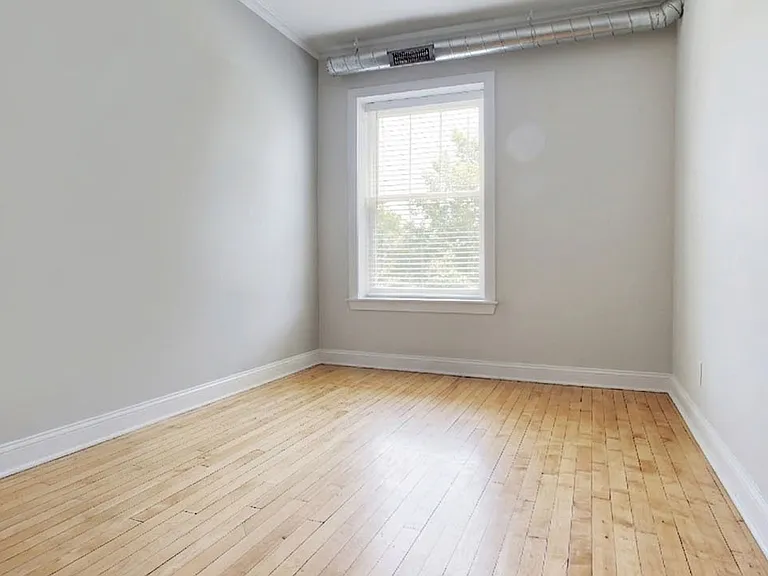 Bedroom 1: hardwood floors, ceiling fan, new windows, blinds. Bright and quiet on the Berwyin side of the building.