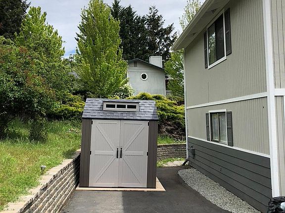 Parking area for tenant. Entrance to apartment is behind the house.