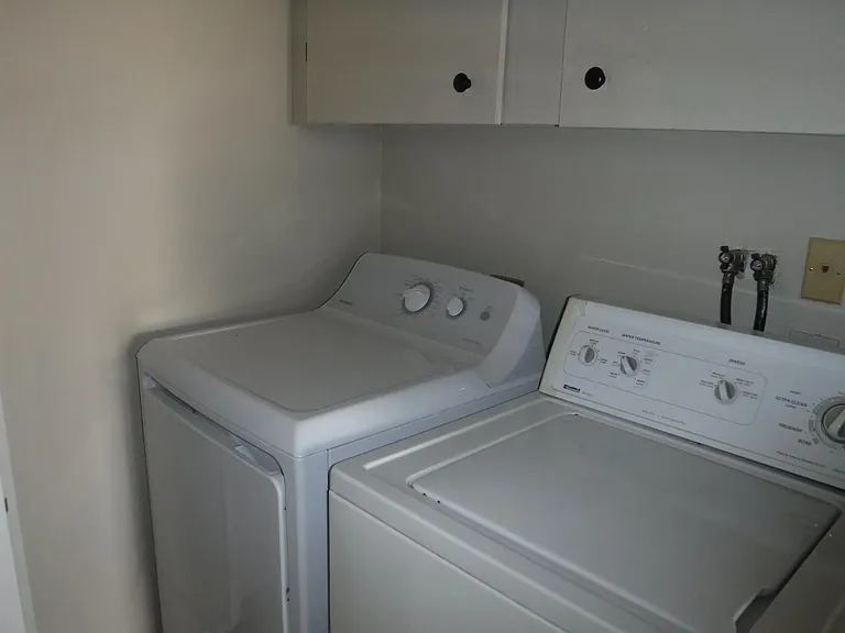 Full sized washer and dryer in laundryroom.