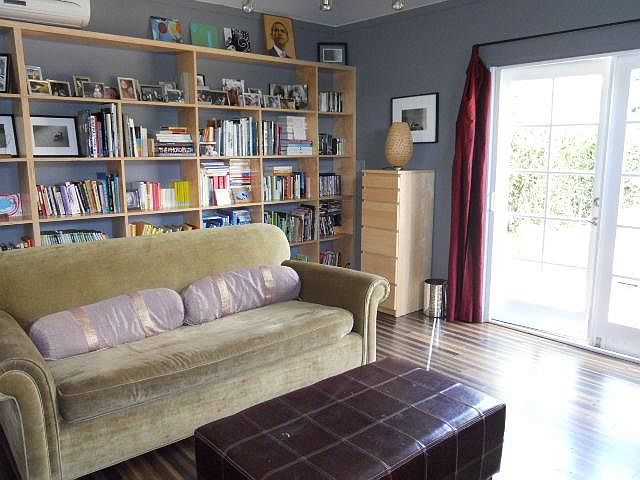 Built-in shelves line the right wall. Alternate setup. Regenerative Farming Dark Bamboo Floors. Air/Heat. Denim Insulation. Double French doors provide beautiful light. Unfurnished.