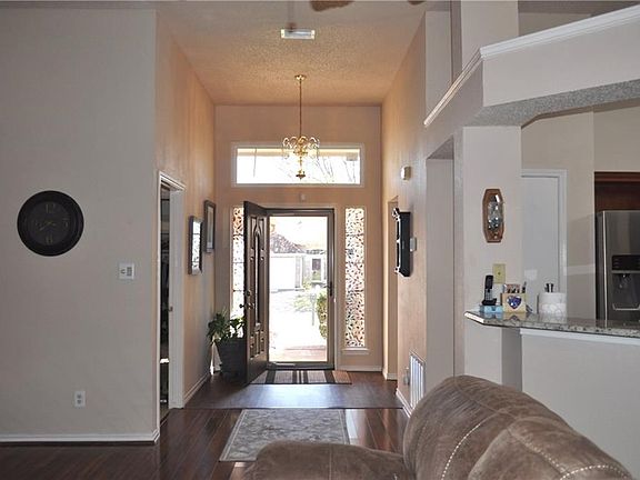 Entry way includes new front door, lovely neutral color scheme greats you.