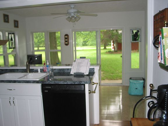View from Kitchen thru back sunroom to back yard