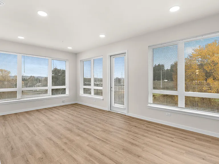 Open living room filled with natural light and wood-style floors. Open living room filled with natural light and wood-style floors.