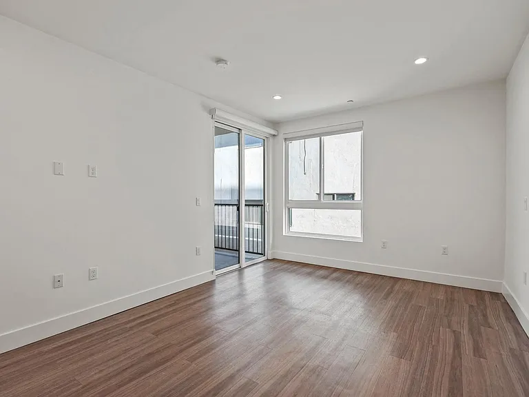 Bedroom with Recessed Lighting, Vinyl Floors, Windows, and Patio