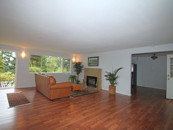 Living Room with gas fireplace, hardwoods, granite fireplace facia