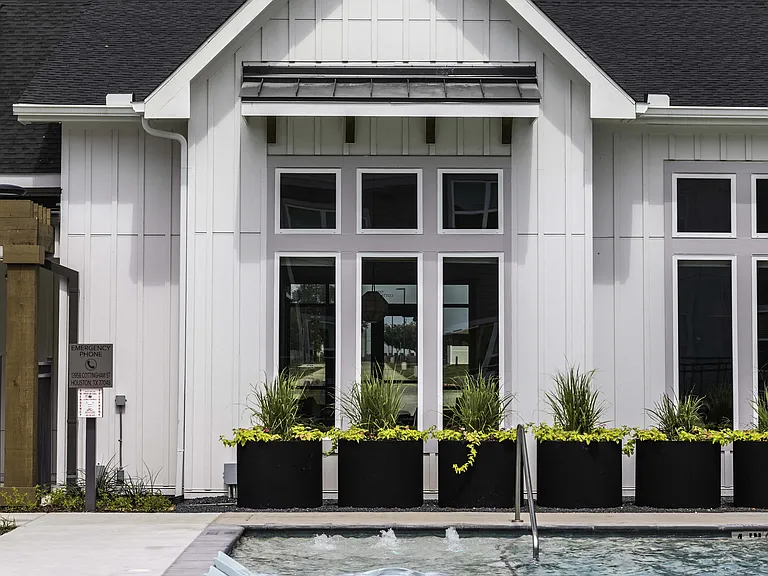 Clubhouse exterior with floating pool chairs