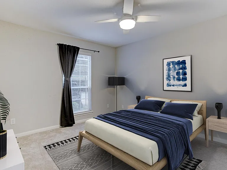 Large bedroom with brand new remote-control fan and walk-in closet.