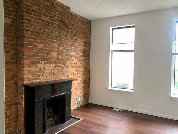 Living Area in the front with exposed brick wall