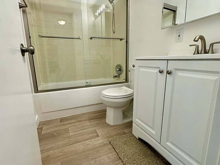 Upstairs bathroom with new flooring, fixtures, shower/tub inclosure and paint!