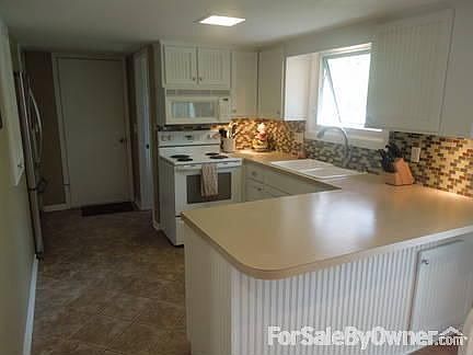 Kitchen : Beautiful glass tiled back splash, refaced cabinets, and pantry.