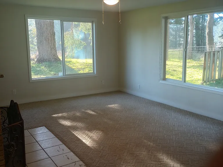 Living room with lots of natural light (shown vacant)