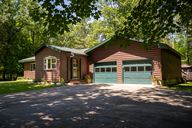 Enjoy a corner lot with a wooded barrier on 3 sides and a front view to the lake.