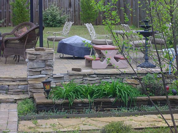 hand paved patio with stone retaining wall