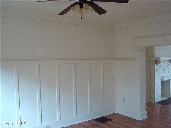 Wainscoting in dining room with ceiling fan