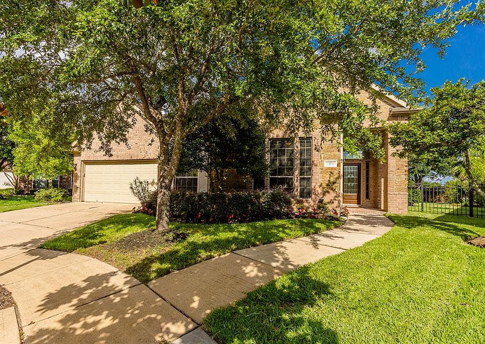Beautiful brick 3/2.5/2 home on a fabulous lot on a cul-de-sac street with a beautiful backyard and gleaming pool.