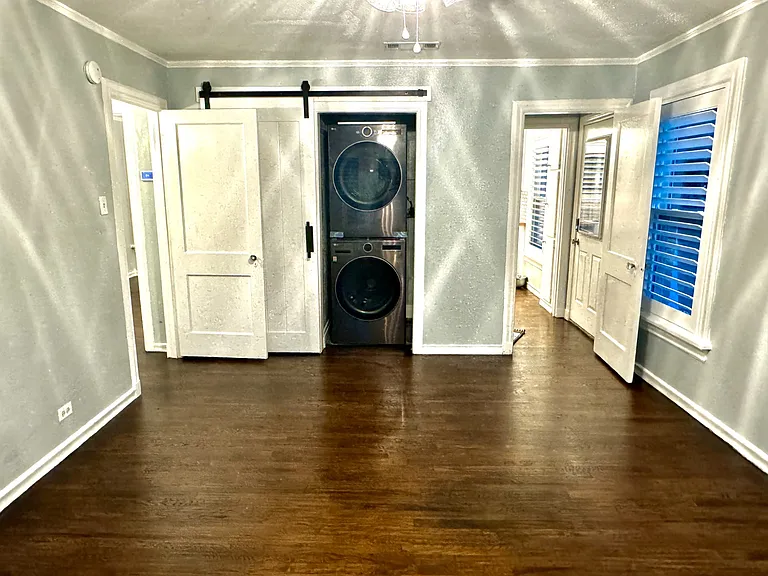 Bedroom with new full-size washer and dryer.
