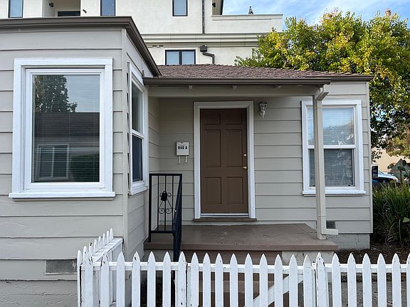 Front entry porch with white picket fence.