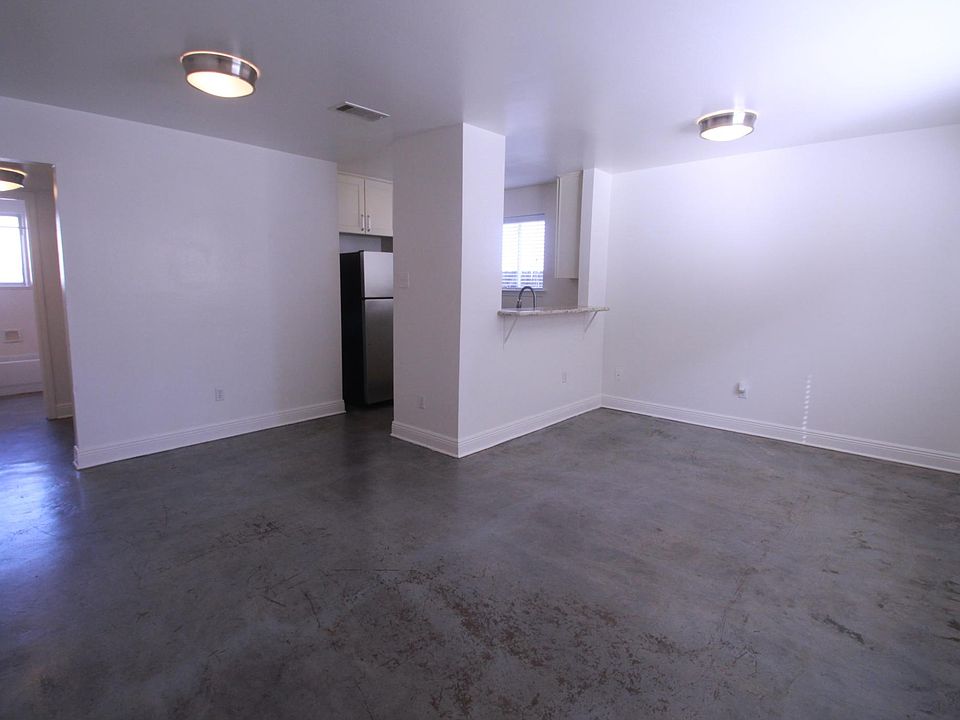 Living room with an open kitchen waiting for barstools.