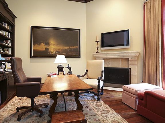 Study overlooks front yard and has warm cozy fireplace