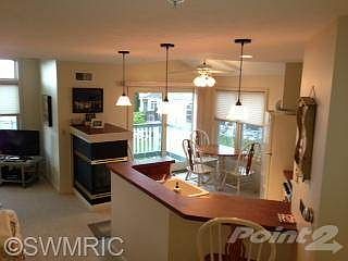 View of kitchen and dining area from stairway.