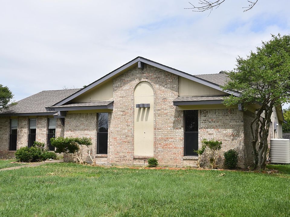 Front of House with contemporary colors. House has 2 car attached garage in back.
