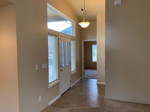 Entry in home to living area. One bedroom is separate from the other two.