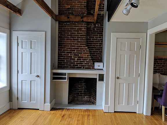 Living room, custom mantle for TV, entertainment, flanked by closets.