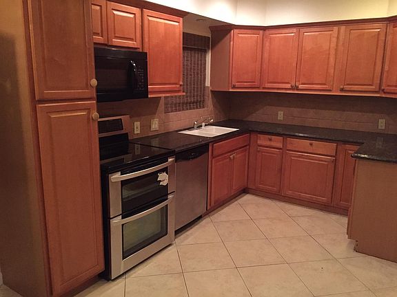 Spacious kitchen with granite counter tops and new appliances.