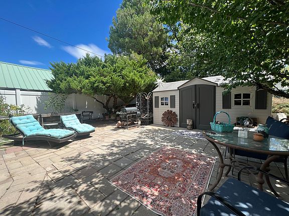 Back yard is private - sunning area, chiminea, firewood stock pile, dining area