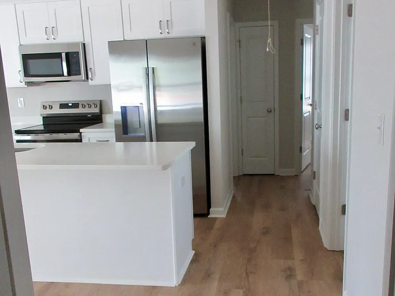 Kitchen viewed from garage entrance; not shown is laundry room with small nook