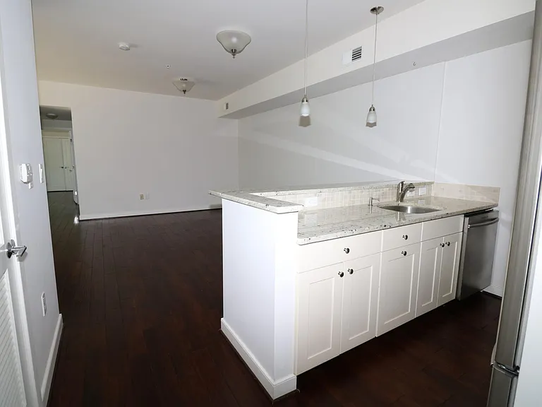 Open kitchen -- stainless steel appliances; breakfast counter