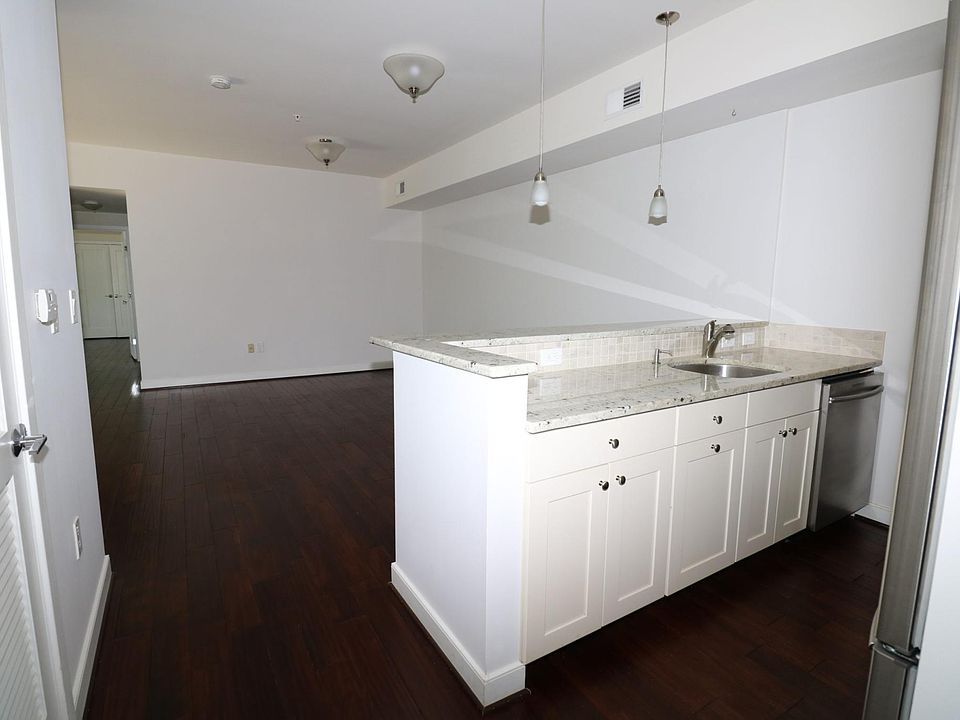 Open kitchen -- stainless steel appliances; breakfast counter