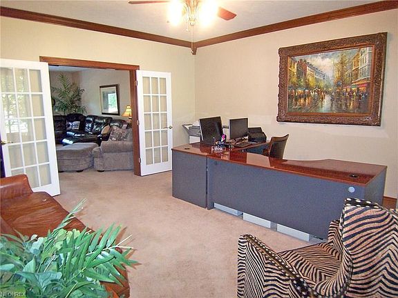 The livingroom is being used as an office area. Its offers a 15 x 15 room with privacy and french doors. Notice the crown molding