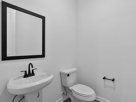 Stylish half bath just steps from the main living area.