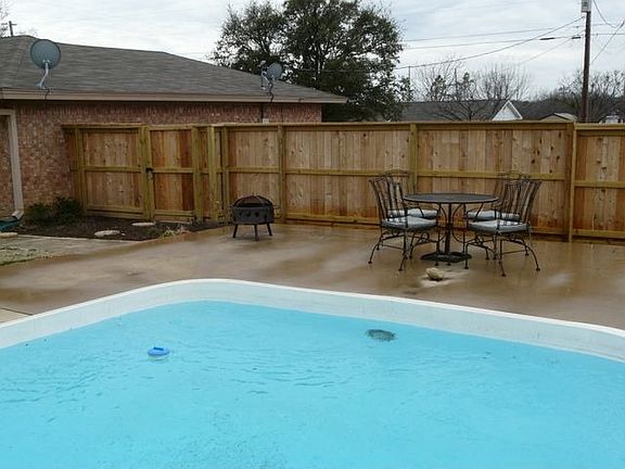 Large swimming pool in oversized backyard.